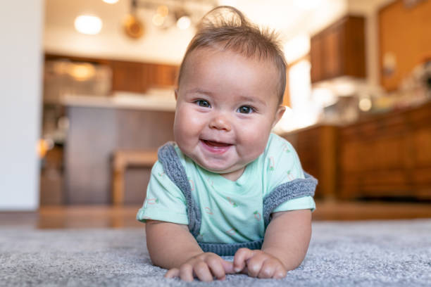 Baby lying on carpet | Hernandez Wholesale Flooring